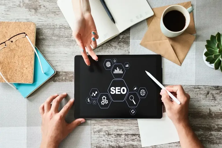 Top view of man and woman working on a SEO project on the iPad on top of the table.