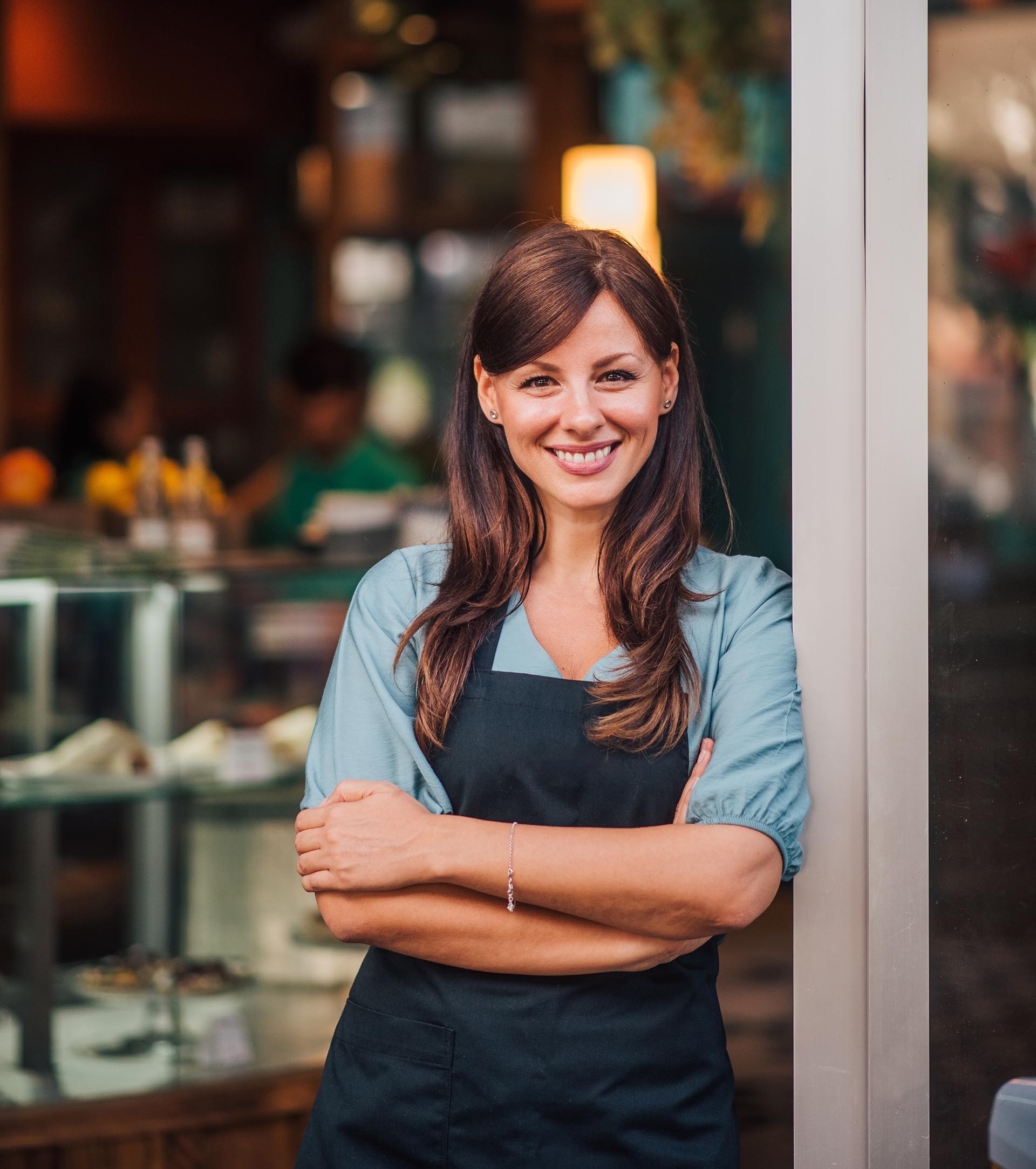 Business owner standing in front of her store.