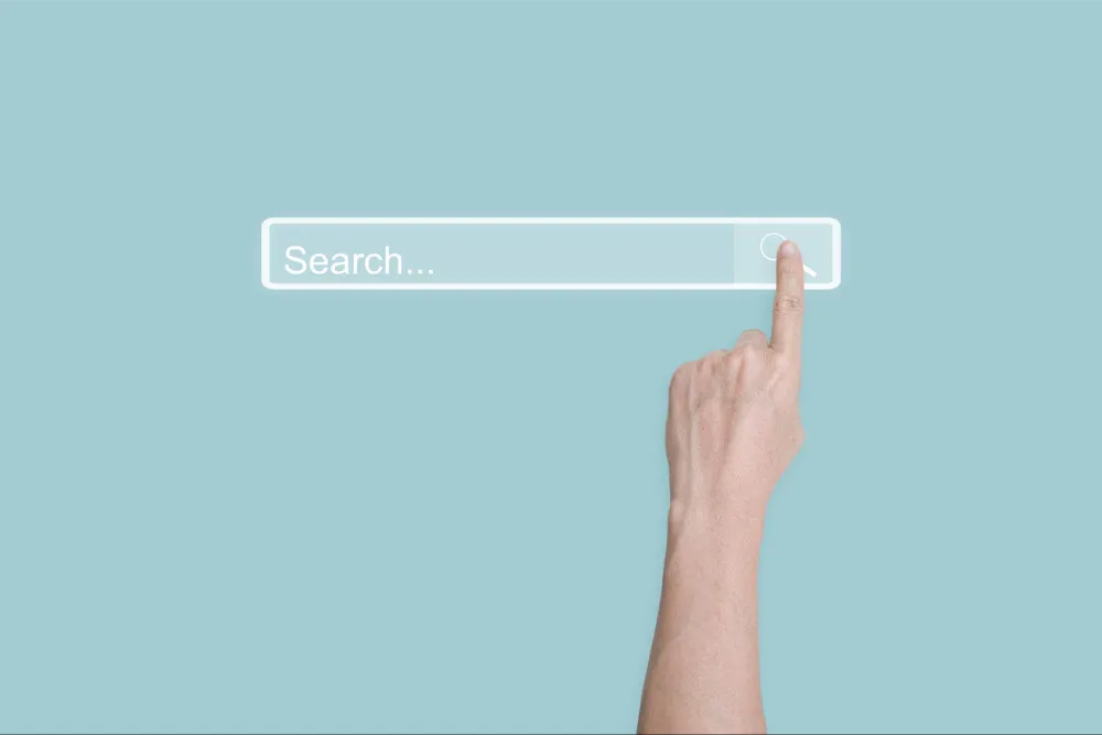 Person pointing towards a search box.