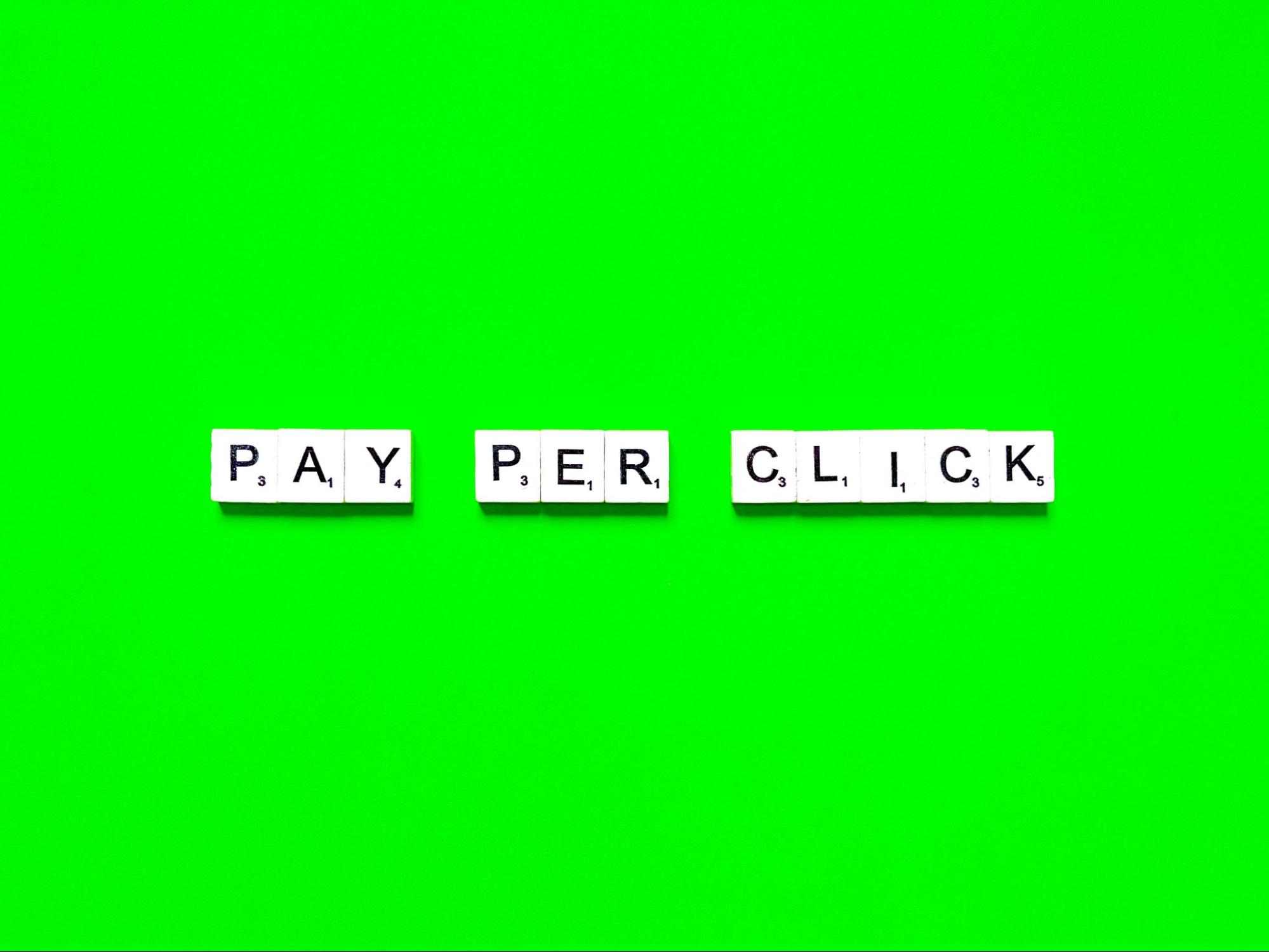 Word “pay per click” written on word tiles.