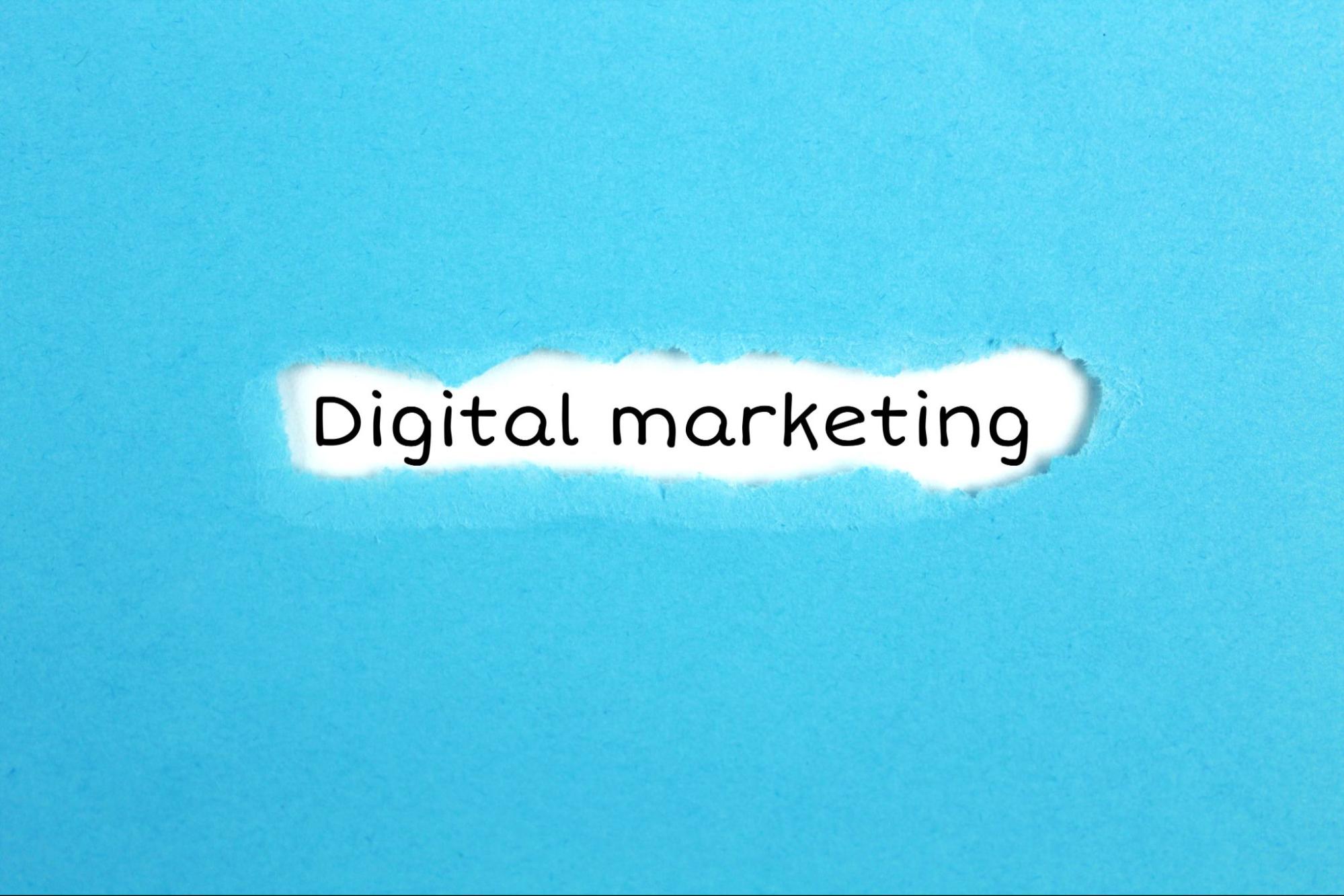 Torn piece of paper around the words “digital marketing.”